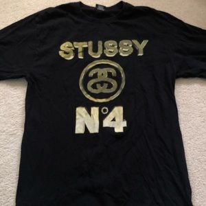 Stussy Men's Black Tee with Gold Logo